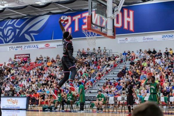 A Harlem Globetrotters player throws down a slam dunk during an event at Shenandoah University in 2021